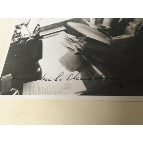 2049 - A 1941 Photograph of Sir Winston Churchill working whist on a train and signed by Sir Winston Church... 