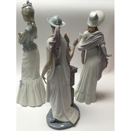 872 - Three large Lladro ladies including Art Deco style maiden with flowers in a vase on plinth and two i... 