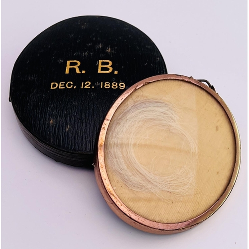 2023 - A lock of Robert Browning's hair in a yellow metal pendant mount and cased in a leather box with the... 