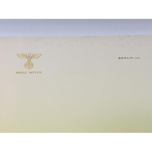 2067 - A single sheet of gilt letter headed paper from the desk of Adolf Hitler, Berlin. Folded, Den. (Corn... 