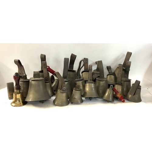 2110 - A collection of church hand bronze bells with lettering impressions on straps.