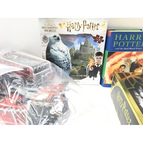 104 - A Collection of Harry Potter Items including 2 First Edition Books. Puzzles. And a Memory set.