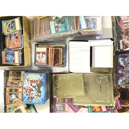 112 - A Box Containing A Collection of Yu-Gi-Oh Cards and Tins.