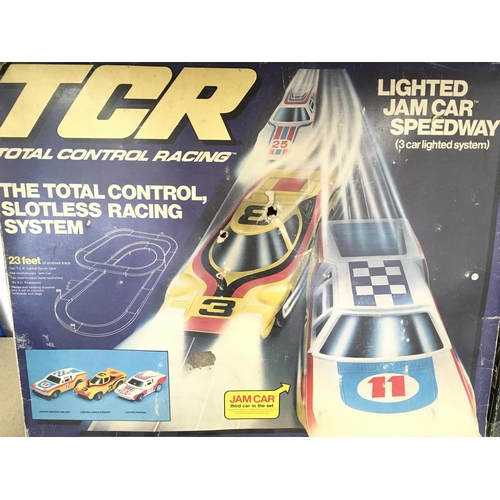 119 - A Boxed TCR Racing Set and a M&S Italian Job Racing Set.(2)