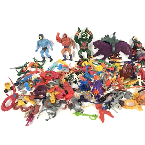 266 - A large collection of various action figures and accessories including he-man.