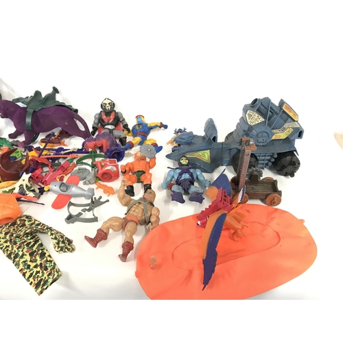 266 - A large collection of various action figures and accessories including he-man.