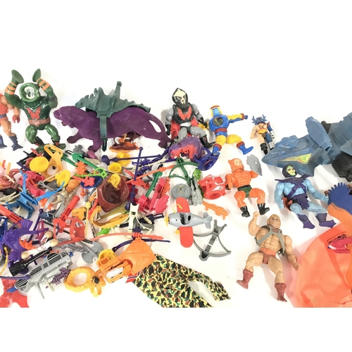 266 - A large collection of various action figures and accessories including he-man.