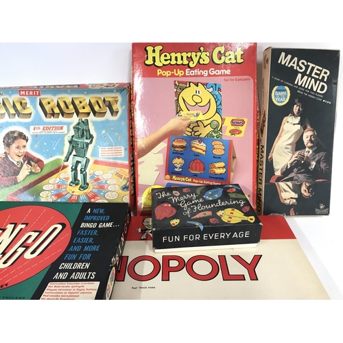 310 - Collection of various board games including magic robot and the action man game.