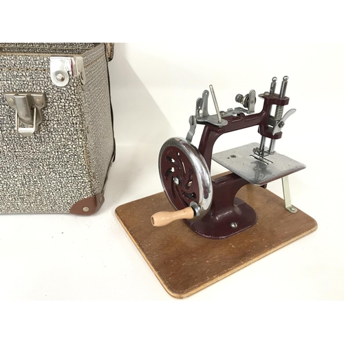 391 - An Essex miniature sewing machine with carry case and manual.