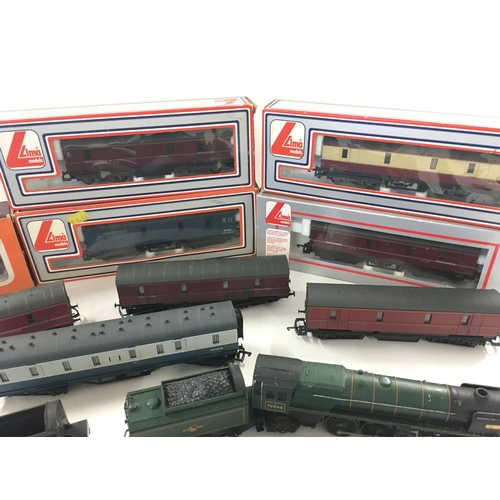 766 - A Box Containing a Collection of 5 00 Gauge Locomotives and Boxed Carriages.