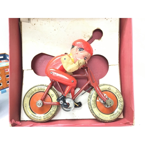 83 - A Vintage Tri-Ang Gyro Cycle and a Vintage Tin plate Battery operated toy.(2).