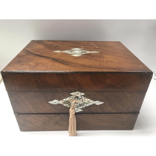 712 - A Victorian walnut sewing/ writing box inlaid with mother of Pearl.