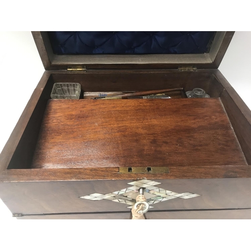 712 - A Victorian walnut sewing/ writing box inlaid with mother of Pearl.