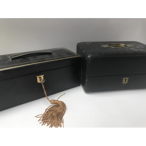 713 - Two Edwardian leather vanity cases with fitted interiors .