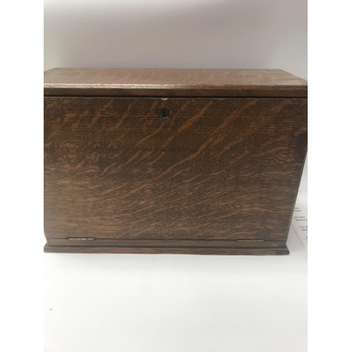 715 - A oak stationary box with fitted interior.