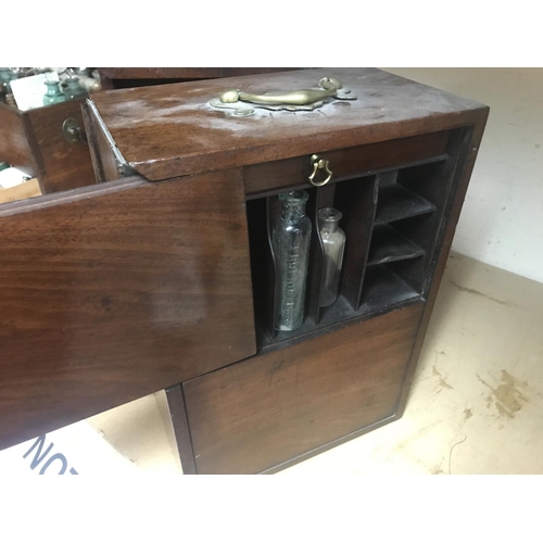 718 - A Georgian mahogany apothecary box enclosing six drawers and glass bottles.