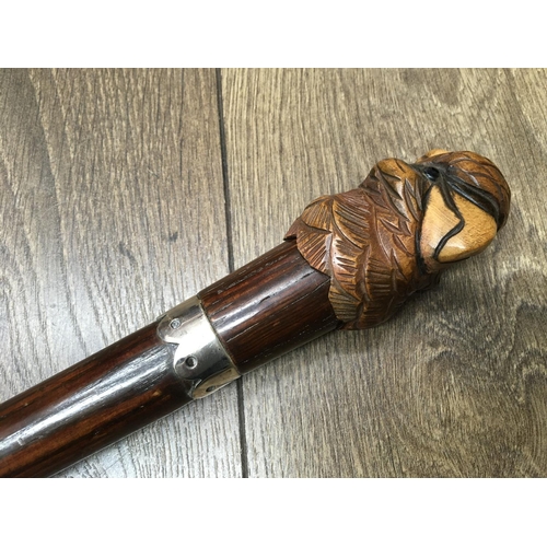 734 - A novelty walking stick with carved parrot handle