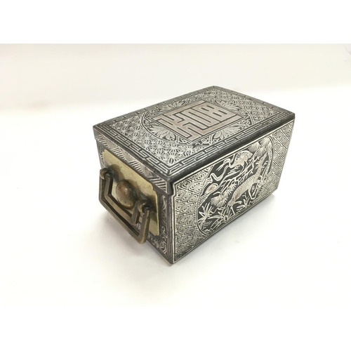 738 - An Oriental white metal and bronzed box with stag, roe and bird decoration to side panels and push b... 