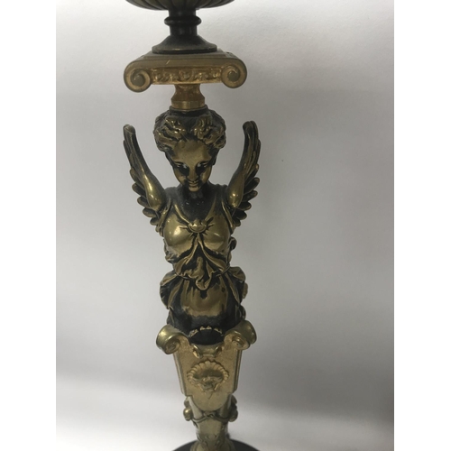 746 - A pair of Empire style candle sticks in the form of classical figures on circular bases on claw feet... 