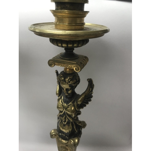 746 - A pair of Empire style candle sticks in the form of classical figures on circular bases on claw feet... 