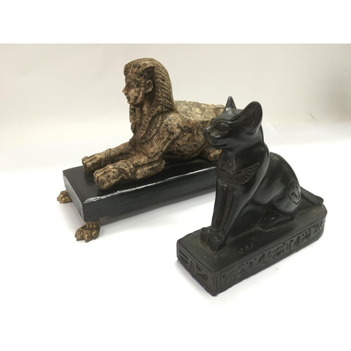 773 - An old figure of an Egyptian sphinx, approx height 14cm and an Egyptian cat (2).