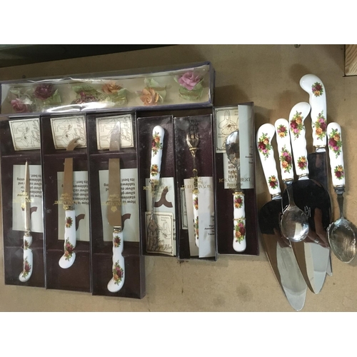 821 - A collection of boxed and loose Royal Albert cutlery in Old Country Roses pattern.