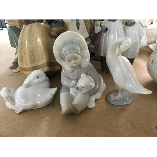 860 - A collection of 21 Lladro figures including cherubs and children ducks doves and geese. No damage or... 