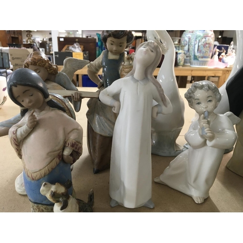 860 - A collection of 21 Lladro figures including cherubs and children ducks doves and geese. No damage or... 