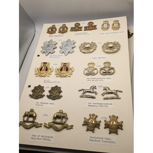 2028 - An album containing military collar badges mounted on four cards with detailed descriptions.