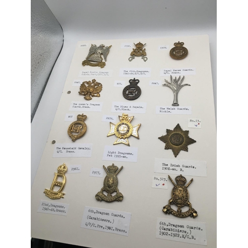 2036 - A collection of military cap badges predominantly Dragoon's Guards and others mounted on five cards.