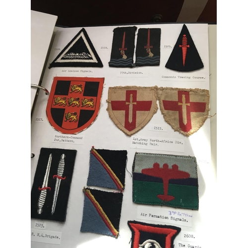 2038 - An album containing cloth embroidered Military Divisional sign badges mainly II world war.