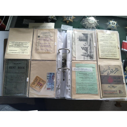 2055 - An album containing military and war related ephemera and postcards including a Lewis gun handbook a... 