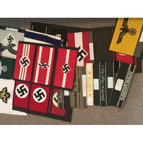 2070 - A collection of German Third Reich arm bands and cuff titles and other cloth badges most possible re... 