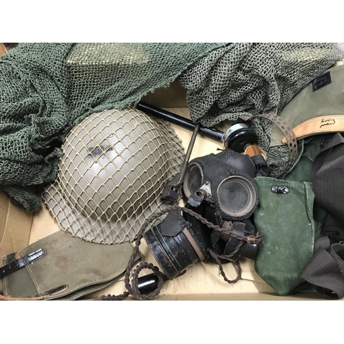 2289 - A box containing Military items including tin helmet, gas mask, netting, bayonet etc