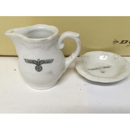 2294 - A German third Reich porcelain cream jug and small dish and a box of oddments including spare medal ... 