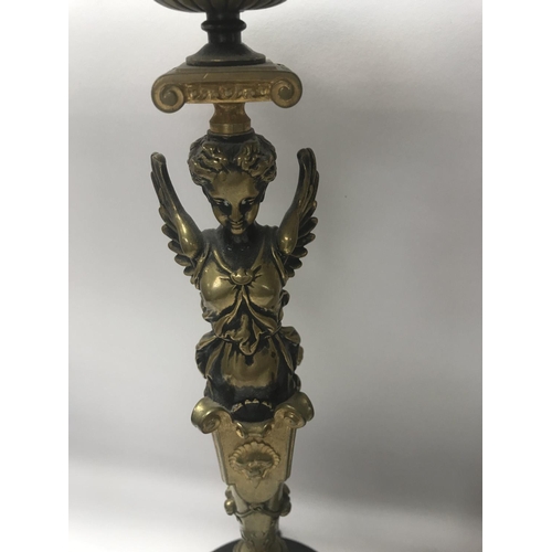 755 - A pair of Empire style candle sticks in the form of classical figures on circular bases on claw feet... 