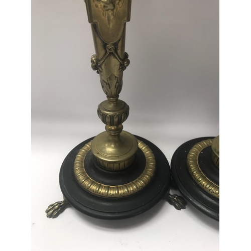 755 - A pair of Empire style candle sticks in the form of classical figures on circular bases on claw feet... 