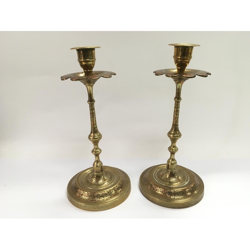 757 - A pair of Indian brass candlesticks, approx height 24cm.