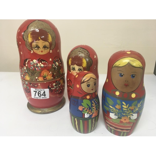 764 - Two Russian painted wood graduating doll sets