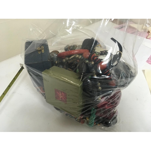 780 - A bag containing a large quantity of costume jewellery (a lot)