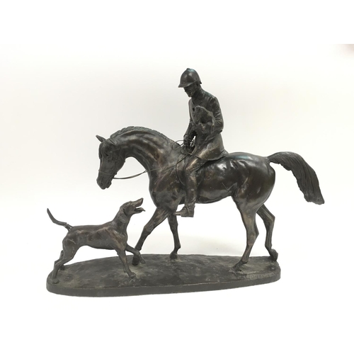 781 - A contemporary sculpture of a huntsman on horseback with hounds.