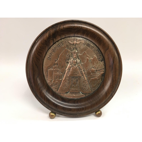 787 - A circular religious plaque in a rosewood frame, signed. Approx diameter 22cm.