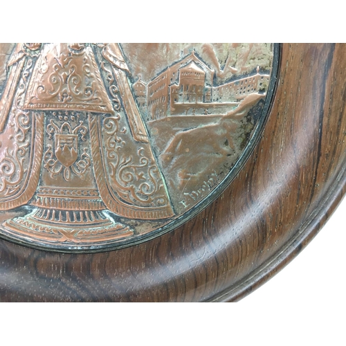 787 - A circular religious plaque in a rosewood frame, signed. Approx diameter 22cm.