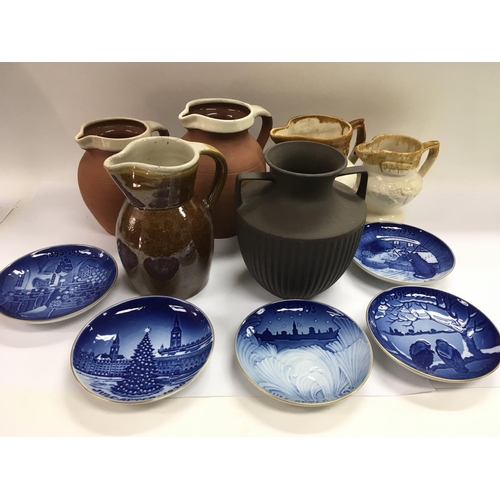 859 - A collection of Bing & Grondahl collection plates plus some pottery jugs.