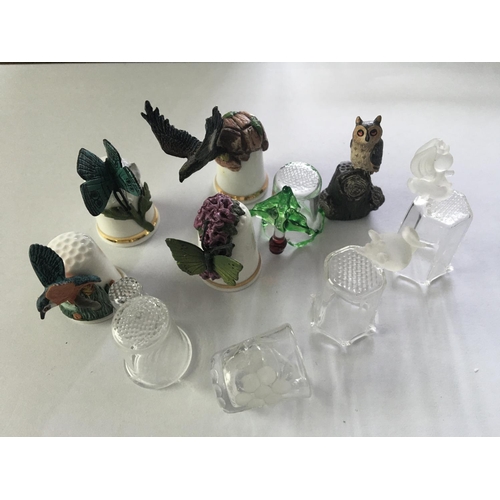 1001 - A small ceramic and glass thimble collection including ones decorated with raised animals