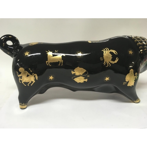 1110 - A Wedgwood Taurus the bull , with gilt signs of the zodiac m designed by 
Arnold Machin  38 cm long ... 