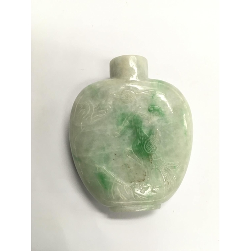 1154 - A carved jade snuff bottle decorated with a crane amongst foliage to one side and a junk to the othe... 