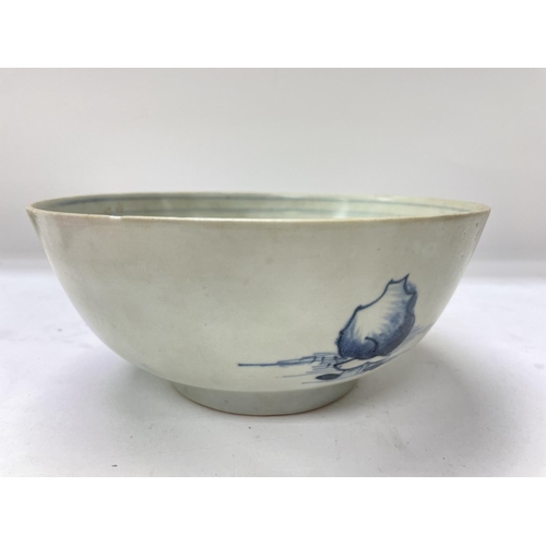 1161 - A Nanking cargo blue and white bowl decorated with landscape view .