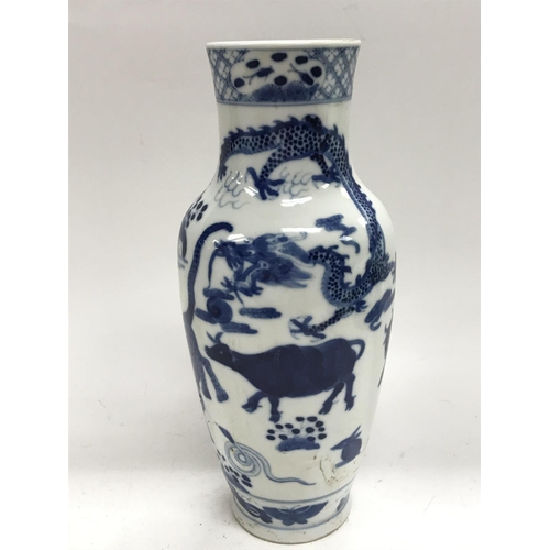 1170 - A blue and white vase, marked to the base and decorated with animals and a dragon, the height is 24c... 