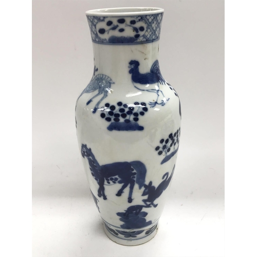 1170 - A blue and white vase, marked to the base and decorated with animals and a dragon, the height is 24c... 